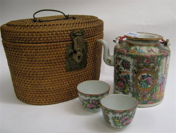 CHINESE PORCELAIN TEA SET IN A FITTED BASKET, the: CHINESE PORCELAIN TEA SET IN A FITTED BASKET, the tea set in Rose Medallion on white ground, consisting of a teapot, 6" H.; together with two tea cups; 2" H., 2-1/4" D.; oval form woven travel basket