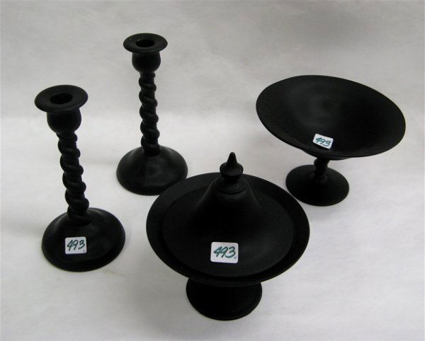 FIVE BLACK AND GREEN GLASS TABLE ACCESSORIES. One: FIVE BLACK AND GREEN GLASS TABLE ACCESSORIES. One is a green thumbprint pattern lemonade pitcher, applied clear handle, 9-1/4" H.; together with a pair of black satin glass twist candlesticks, 9-1/4"