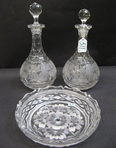 CLEAR CUT AND ENGRAVED GLASS TABLE ACCESSORIES: 3: CLEAR CUT AND ENGRAVED GLASS TABLE ACCESSORIES: 3 pieces: two liquor decanters, each cut and engraved in frosted rose decoration, with faceted stoppers, 10-3/4" and 10-1/8" H.; plus a signed Libby, sh
