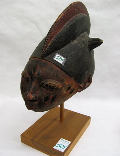 A HAND CARVED WOODEN AFRICAN HELMET attributed to 