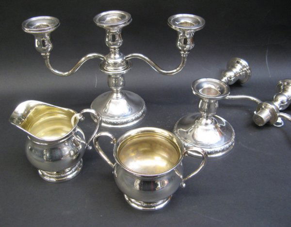 FOUR STERLING SILVER TABLE ACCESSORIES, Internati: FOUR STERLING SILVER TABLE ACCESSORIES, International Sterling Co., in the Prelude pattern: pair of candelabra, convertible from three-light to single candleholders, 6-1/4" H. to 3-1/2" H.; together w