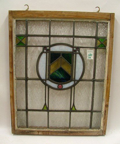 TWO WINDOW PANELS: the first an English stained a: TWO WINDOW PANELS: the first an English stained and leaded glass window having circular opalescent and colored glass center, in wood sash, overall 23 in. by 29 in.; the second an etched design of a sh
