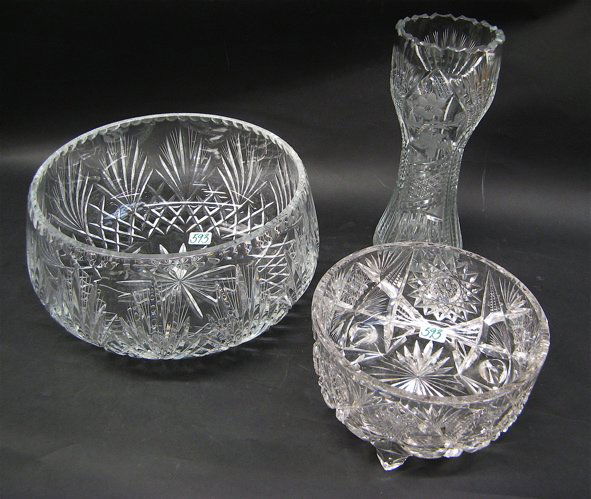 THREE AMERICAN CUT GLASS TABLE ACCESSORIES: THREE CUT GLASS TABLE ACCESSORIES: American Brilliant Period tri-footed fruit bowl, 8" D.; large centerpiece bowl, 11" D.; together with the cut and engraved vase, 10-1/2" H.