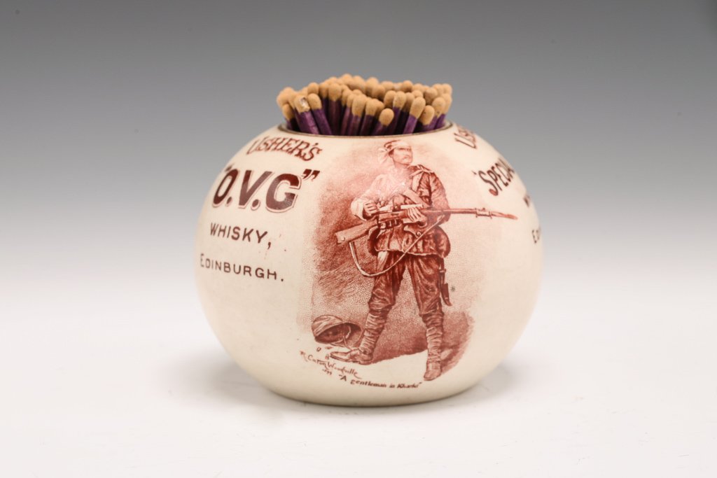 Usher's Whisky Advertising Match Striker: A Raphael Tuck & Sons London stoneware advertising match striker. Featuring a Boer War period transferware copy of R. Caton Woodville's "A Gentleman in Khaki", Usher's Special Reserve Whisky and The A
