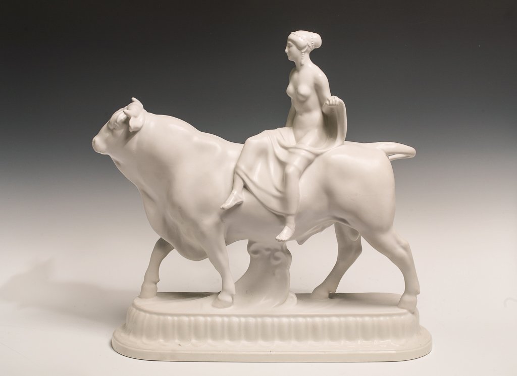 KPM Porcelain Scultprue "Europa and the Bull": An early 20th century KPM figural sculpture in white on white depicting Europa riding a bull. The figure is marked underneath with the blue scepter mark.