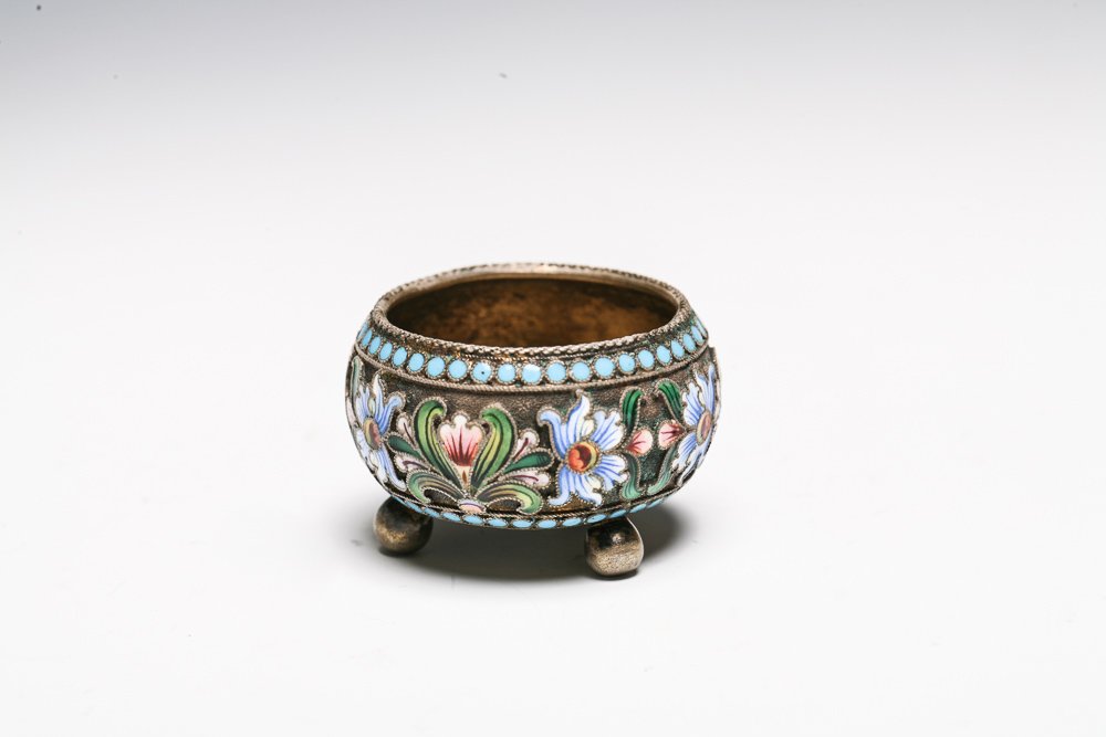 Imperial Russian Enameled Salt Cellar: A small gilt silver open salt with enameled floral decoration around middle. Stands on thee ball feet. Hallmarked on base "МС" for Mikhail Sokolov and First Kokoshnik mark.Weight: 32 grams
