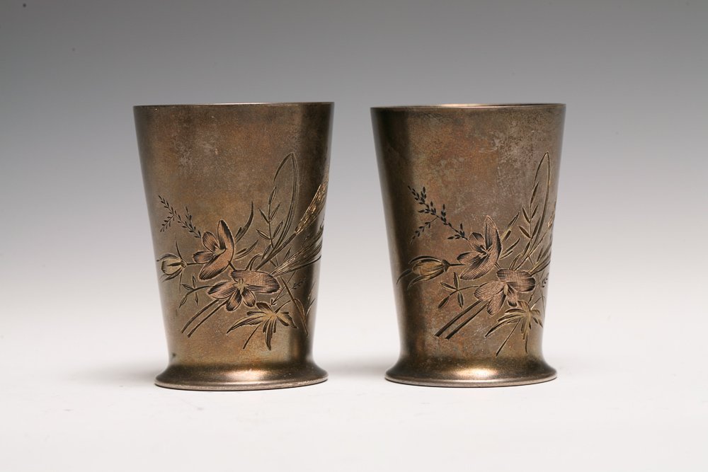 Pair Russian Silver Shot Glasses: A pair of Russian 84 silver shot glasses with integral flared foot, hand chased with flowers and wheat. Parcel gilt interiors. Marked on base with first Kokoshnik Mark and BA for silversmith Vasily An