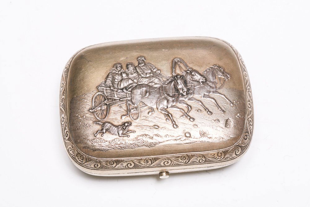 Imperial Russian Troika Cigarette Case: A fine, Imperial Russian parcel gilt repoussé cigarette case featuring a horse troika pulling a wagon with a dog running beside on the front, and a conjoined monogram inside a belt on the reverse. Ha