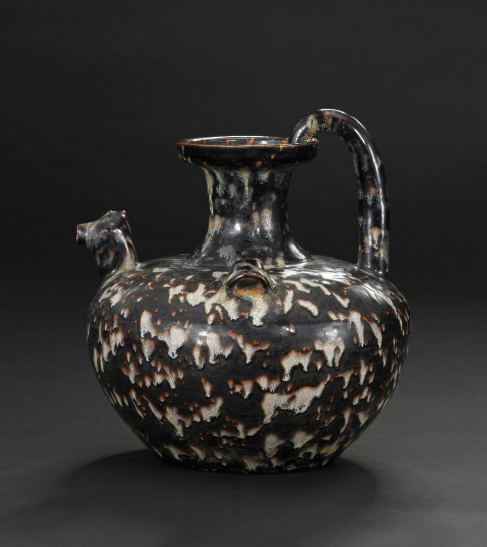 Ji-Chou 'Tortoise Shell' Chicken-Head Ewer: The compressed globular body mounted with a chicken head spout on the shoulder and a pair lugs, the flared mouth rim attached with a tubular handle on the opposite shoulder, applied overall with a dar