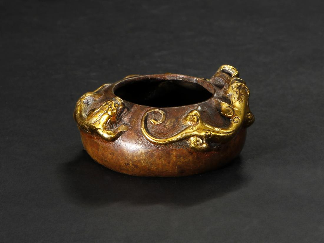 Chinese Bronze Incense Burner: Carved with three dragons, the base with an apocryphal four-character Xuande mark. Height 1 in., Width 2 1/2 in.