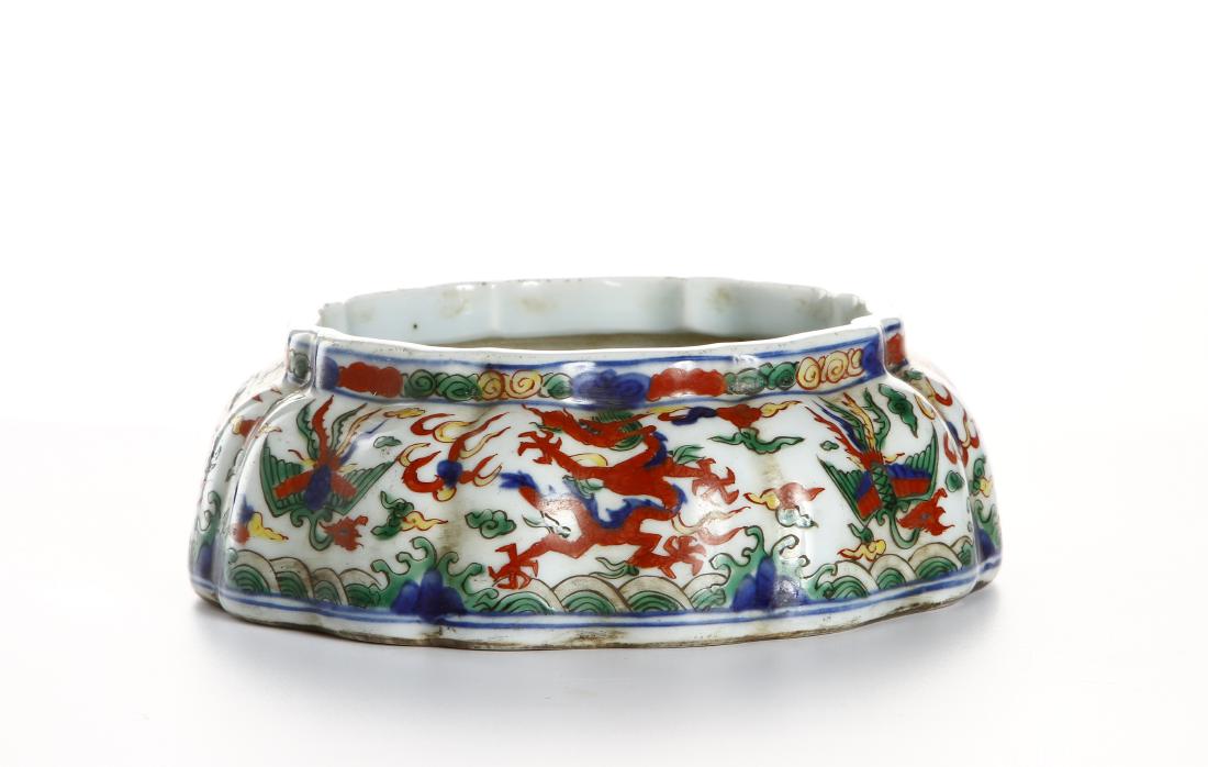 Wucai Lobed 'Dragon-Phoenix' Brushwasher: Of lobed form tapering to a foliate rim, painted around the exterior in vivid green, yellow and iron-red enamels on underglaze blue with confronting dragons and phoenix amidst ruyi clouds contesting a