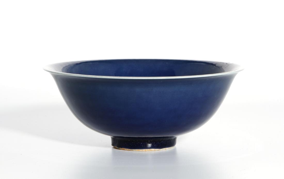 Blue Glazed Bowl: The deep rounded sides supported on a slightly tapered foot, covered overall with a soft yellow glaze slightly pooling to a deeper tone on the inside and around the foot, the base reserved in white an