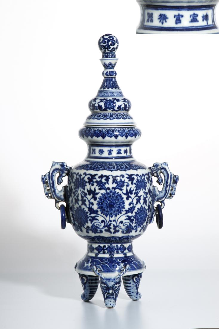 Blue and White Tripod Censer With Cover: Of baluster shape with ovoid body flanked by a pair archaistic dragon handles each suspending a loose ring, rising to a waisted neck to a flared dish mouth rim, all on a splayed base supported on