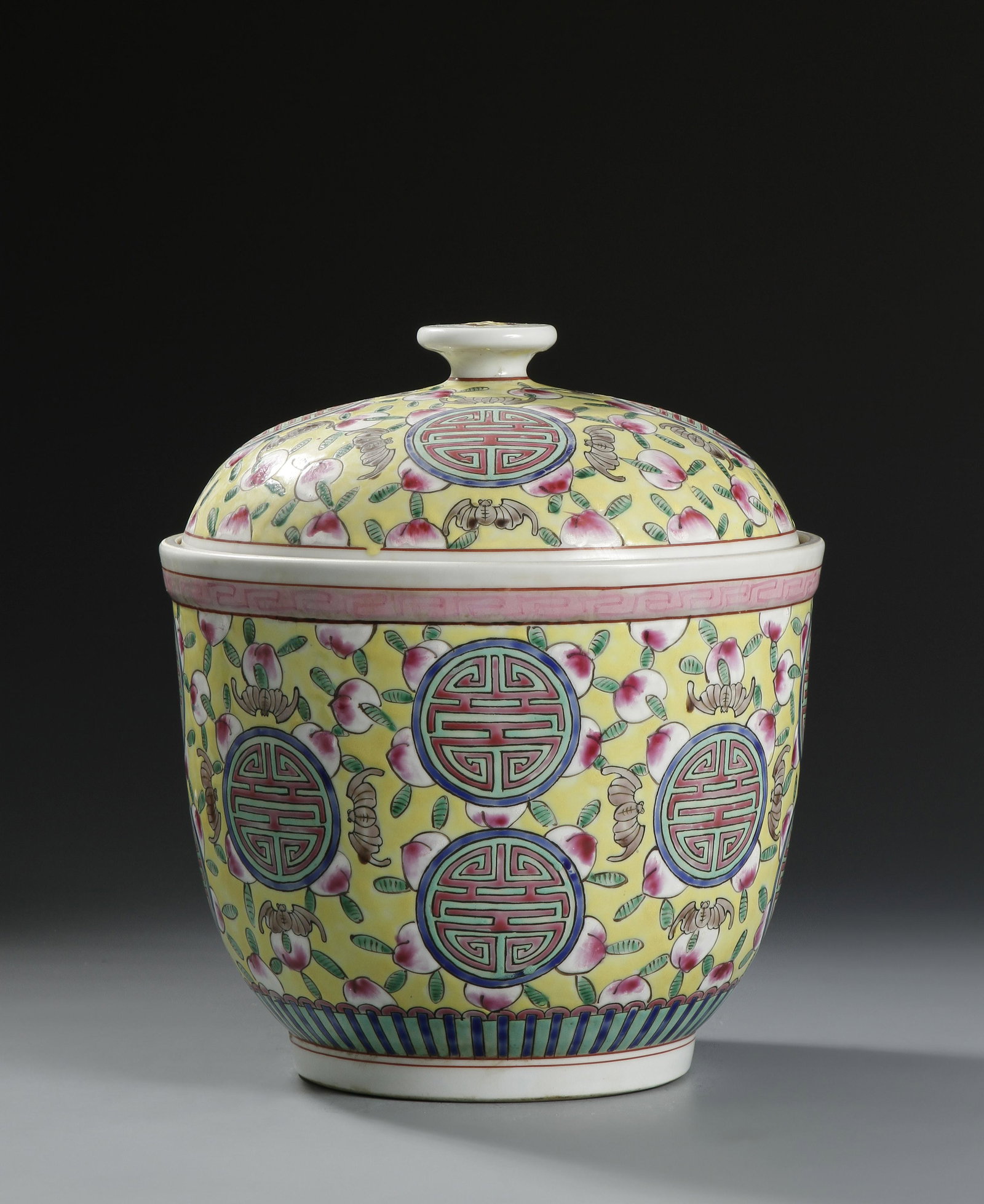 Chinese Yellow Ground Famille Rose Jar: Painted with wan motifs and dense peaches, all reserved on a yellow ground, the base with Kangxi mark. Height 10 1/2 in., Width 9 in.