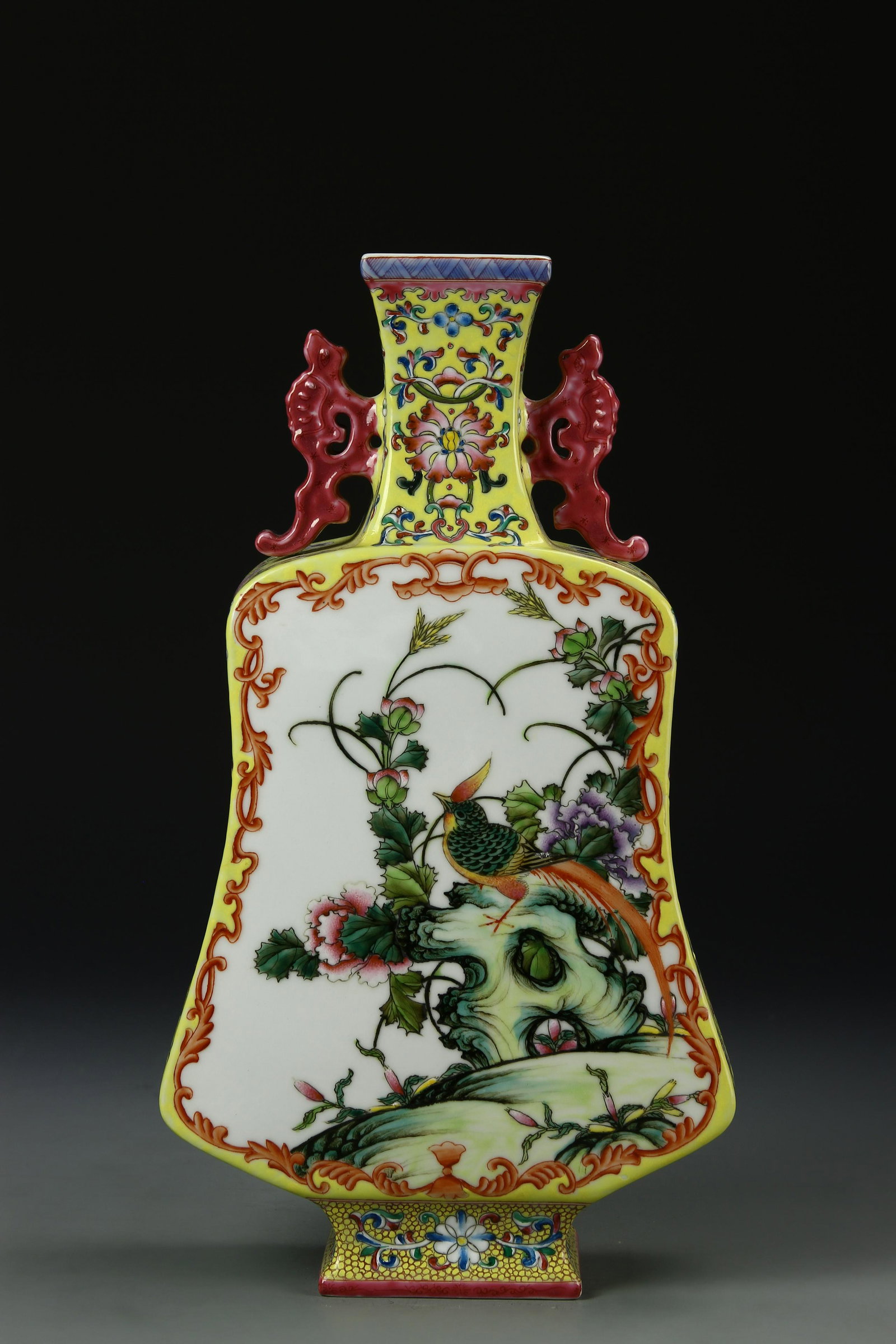 Chinese Famille Rose Vase: In a shape of plantain fan, the body painted with birds and blossoms, the sides and the neck with floral sprays on a rich yellow ground, the base with six-character seal mark. Height 13 3/4 in.