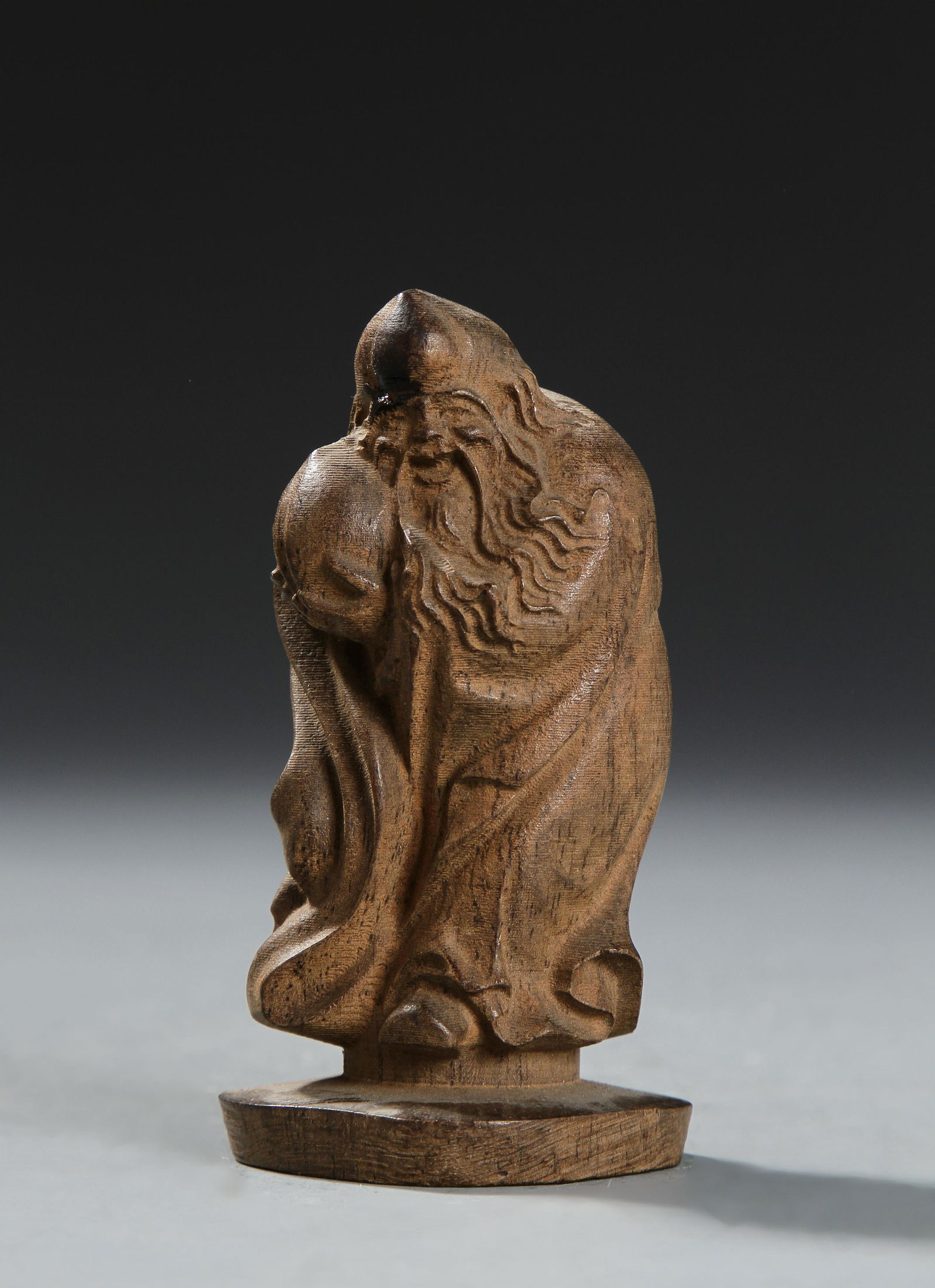 Chinese Wooden Figure of Shoulao: Depicted Shoulalo wearing a long robe and holding a peach. Height 3 1/2 in.