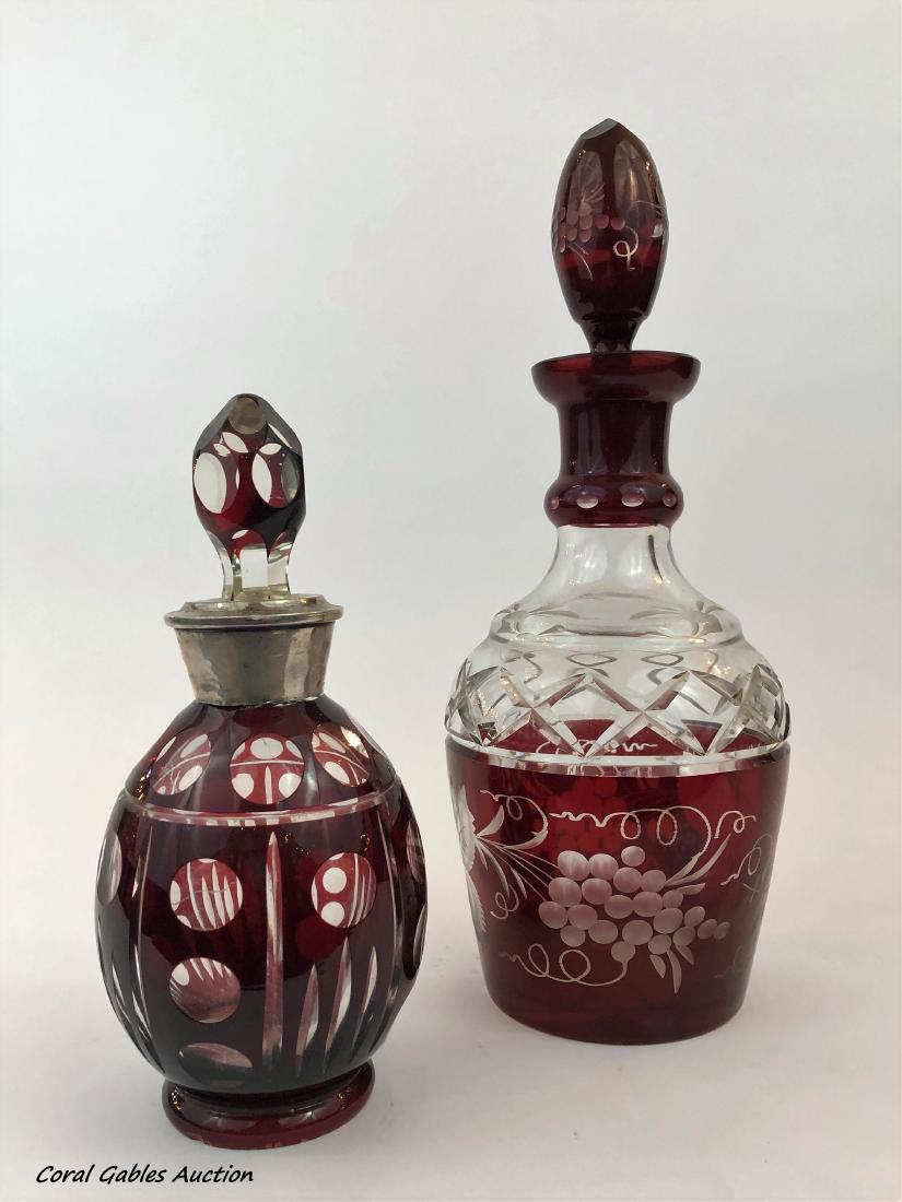 Two bohemian glass bottles: Two bohemian glass bottles. Measure 8 1/2"in H and 12 1/2"in H.