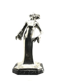Art nouveau period female figure with long robes on a green marble base