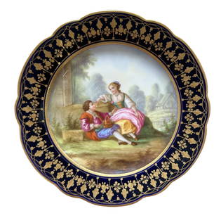 French Sevres Hand-Painted Porcelain Plate with Cobalt Border, Signed Boucher: Elegant French Sevres porcelain cabinet plate featuring a beautifully hand-painted romantic scene of a couple seated in a lush garden landscape. The finely detailed artwork is signed "Boucher" on the