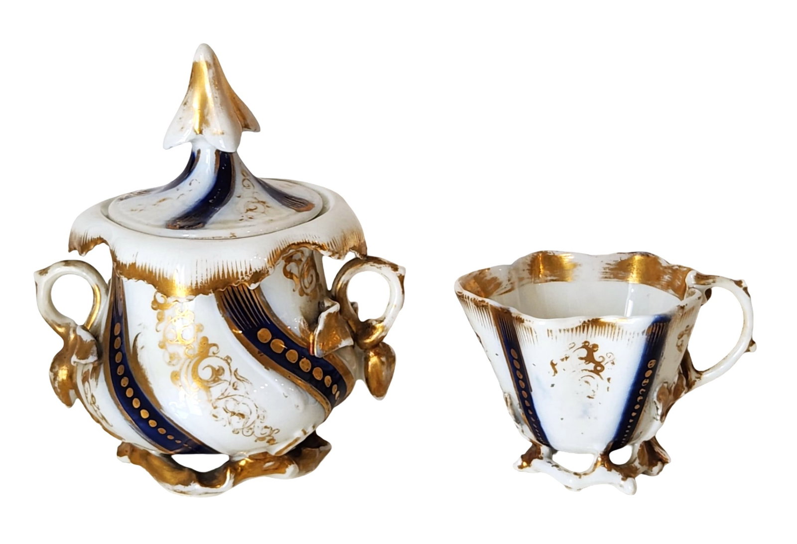 Antique Porcelain Sugar Bowl & Creamer Set, Hand-Painted Cobalt & Gilt, Crossed Swords Mark: Exquisite antique porcelain sugar bowl and creamer set featuring an ornate Rococo Revival design with rich cobalt blue ribbons, intricate gilt detailing, and sculpted handles and feet. The lidded suga