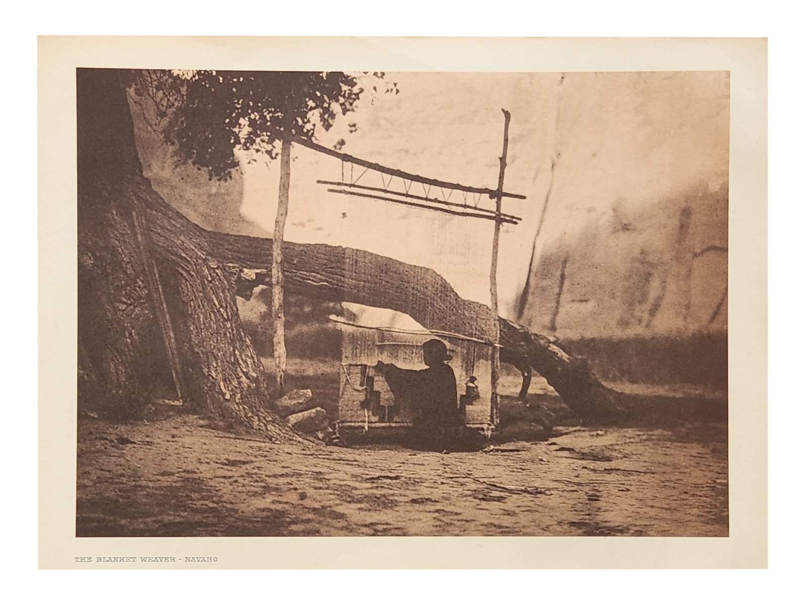 Edward Sheriff Curtis (1868 - 1952) American: Edward Sheriff Curtis (1868 - 1952) American Title: The Blanket Weaver - Navaho Print Caption - Engraving Date: 1904 Measure 13"in H x 18"in W no framed The Navaho-land blanket looms are in evidence e
