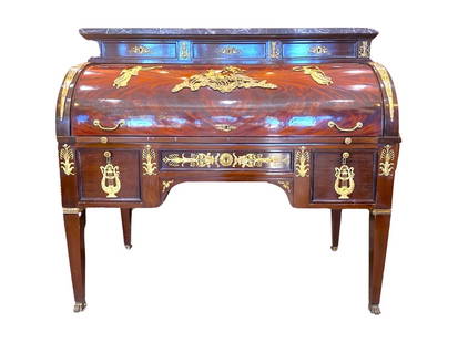 19th Century Empire Style Mahogany and Gilded Bronze Cylinder Desk: Large cylinder desk in mahogany and flamed mahogany veneer in the Empire style. This secretary with semi-cylindrical flap has eight drawers : five on the belt and three on an upper tier, itself topped