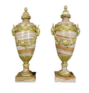 Pair of Grand Neoclassical Style Marble and Gilt Bronze Urns: Magnificent pair of large Neoclassical-style lidded urns crafted from richly veined Sienna marble and adorned with elaborate gilt bronze (ormolu) mounts. Each urn features ornate garland swags, acanth