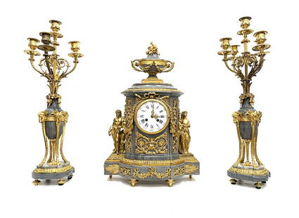 Louis XVI Style Gilt Bronze Mounted Blue Turquin Marble Three Piece Clock Garniture Paris Circa 1875: Louis XVI Style Gilt Bronze Mounted Blue Turquin Marble Three Piece Clock Garniture Paris Circa 1875 The clock features parcel gilt bronze semi nude classical figures of a man and a woman flanking the