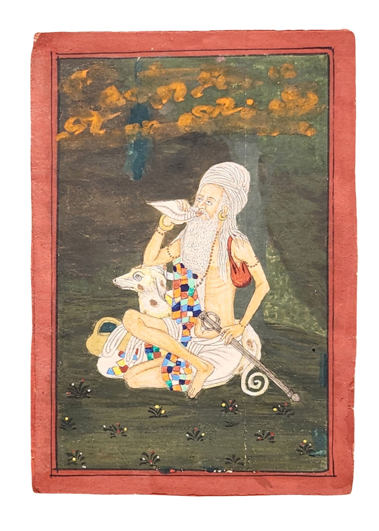 Antique Indian Miniature Painting – Ascetic Yogi with Conch Shell & Deer, Gouache on Paper: A striking antique Indian miniature painting depicting a seated ascetic or yogi in a forested setting, blowing a shankha (conch shell) with a deer beside him. The figure wears a multicolored patchwork