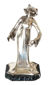 Art nouveau period female figure with long robes on a green marble base