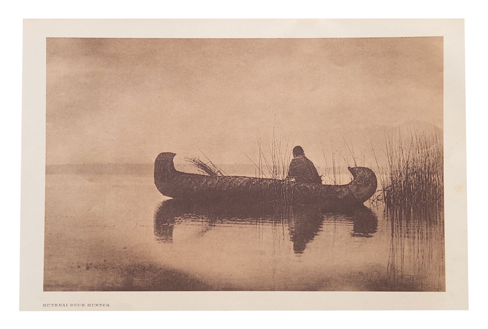 Edward Sheriff Curtis (1868 - 1952) American: Edward Sheriff Curtis (1868 - 1952) American Title: Kutenai Duck Hunter Print Caption - Engraving Date: 1910 Measure 13"in H x 18"in W no framed In the gray dawn of a foggy morni