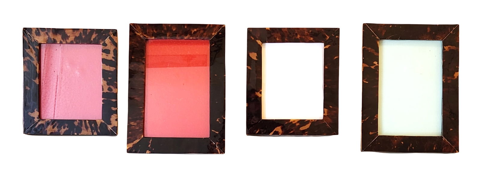Set of Four Faux Tortoise Shell Picture Frames: A coordinated set of four faux tortoise shell picture frames, each crafted with a glossy mottled brown-and-amber finish and fitted with wooden backs and hinged easel stands. The group includes four re