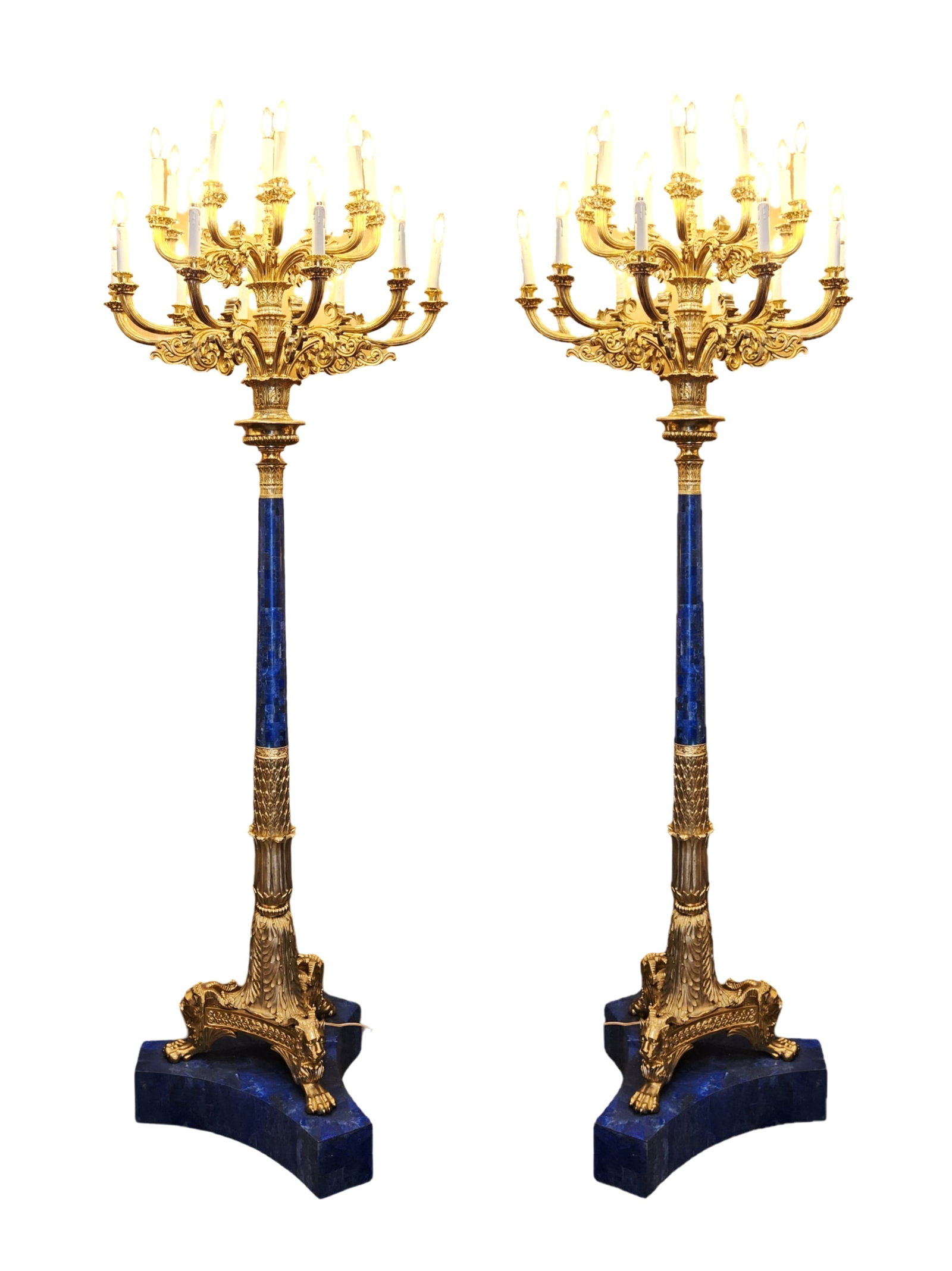 Pair of Large Heuvelmans Interiors Gilt Bronze and Lapiz Lazuli Torcheres: A monumental pair of ormolu and Lapiz Lazuli mounted 19-light torcheres lamps. Each with two tiers of scrolling branches, raised on triangular base with the supports terminating in claw feet Measure 9