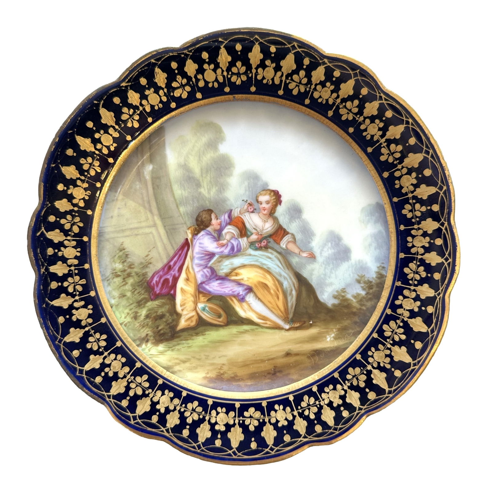 French Sevres Hand-Painted Porcelain Plate with Cobalt Border, Signed Boucher: Elegant French Sevres porcelain cabinet plate featuring a beautifully hand-painted romantic scene of a couple seated in a lush garden landscape. The finely detailed artwork is signed "Boucher" on the