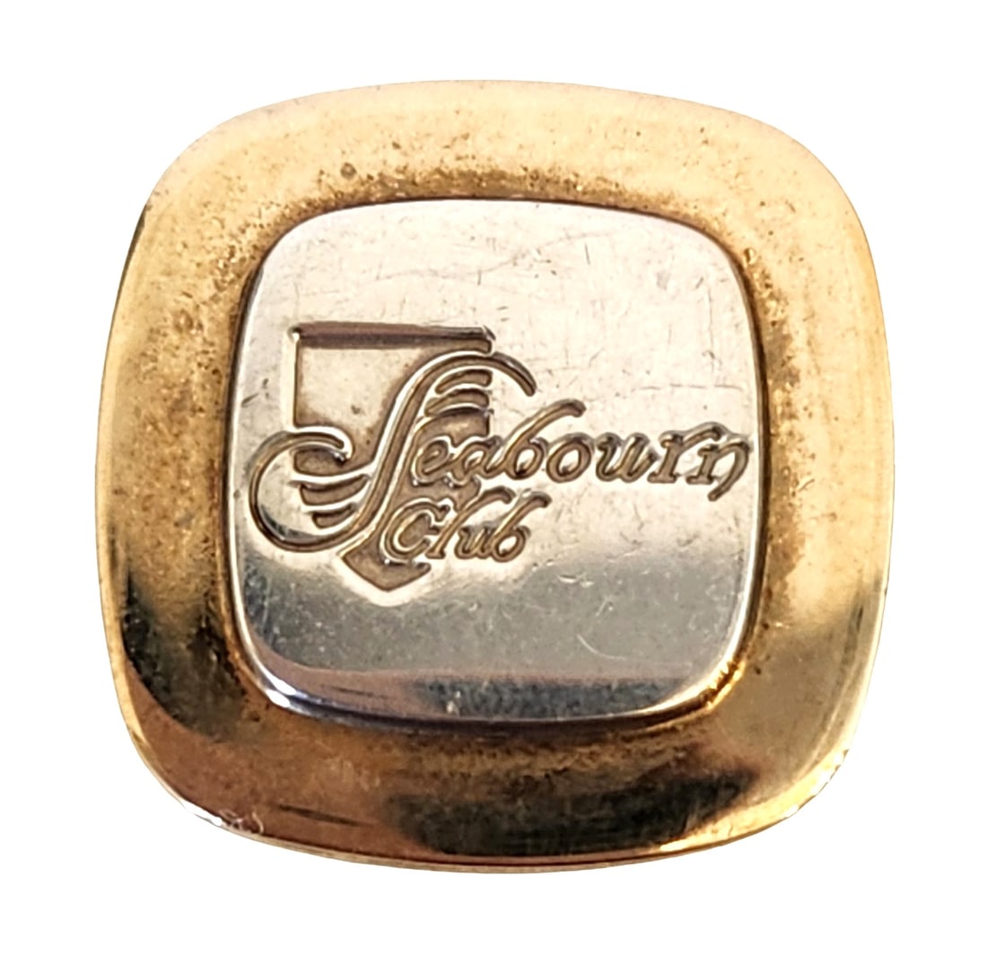 Tiffany & Co. Seabourn Club 18K Gold on Sterling Pin: A rare Tiffany & Co. pin created for the Seabourn Club, crafted in 18K gold over sterling silver. The square-form pin features the Seabourn Club logo engraved on a raised center plaque framed by a gol