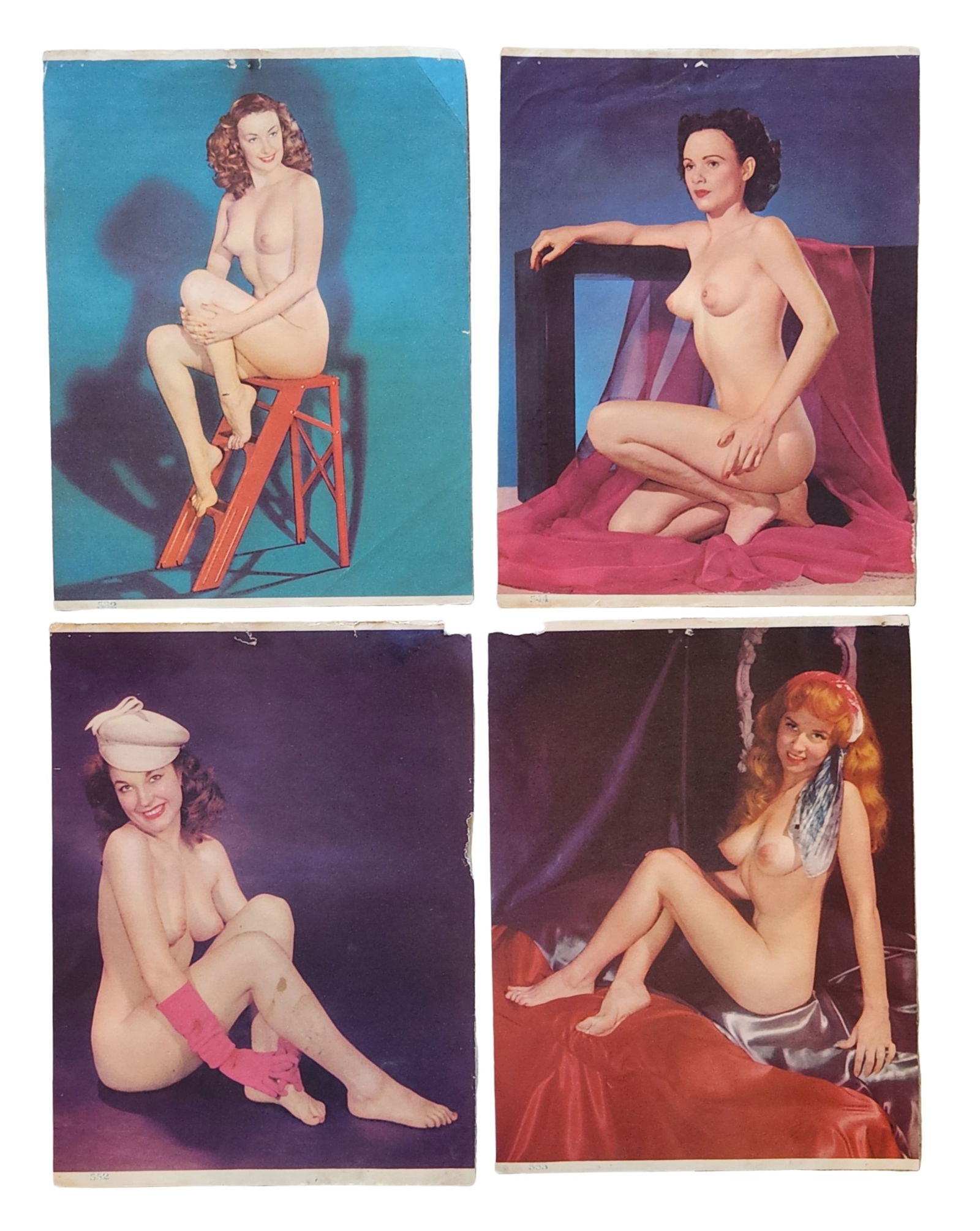 Group of Vintage Color Pin-Up Nude Photography Prints, Mid-20th Century: Group of vintage color pin-up photography prints depicting posed female nude figures in studio settings. The images feature classic mid-20th-century pin-up aesthetics, including staged props, drapery,