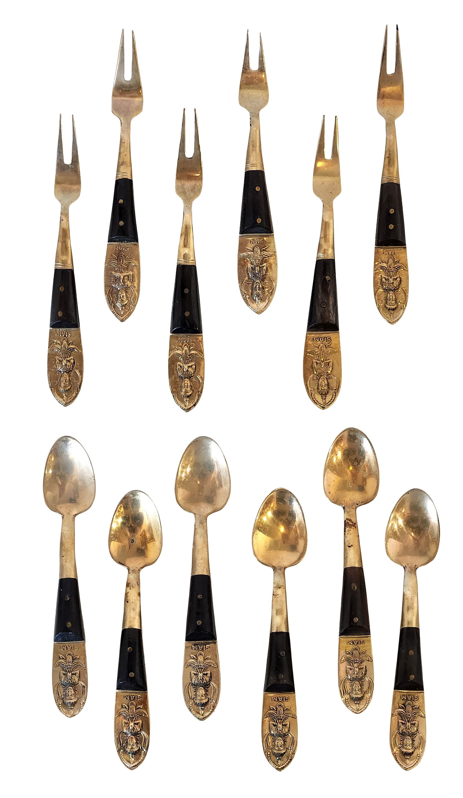 Vintage Siam Brass & Black Handle Appetizer Forks and Spoons – Mixed Set: Vintage Siam-style appetizer utensil set featuring ornate brass handles with a raised seated figure motif and black handles with brass rivets. The set includes small forks and spoons, ideal for appeti
