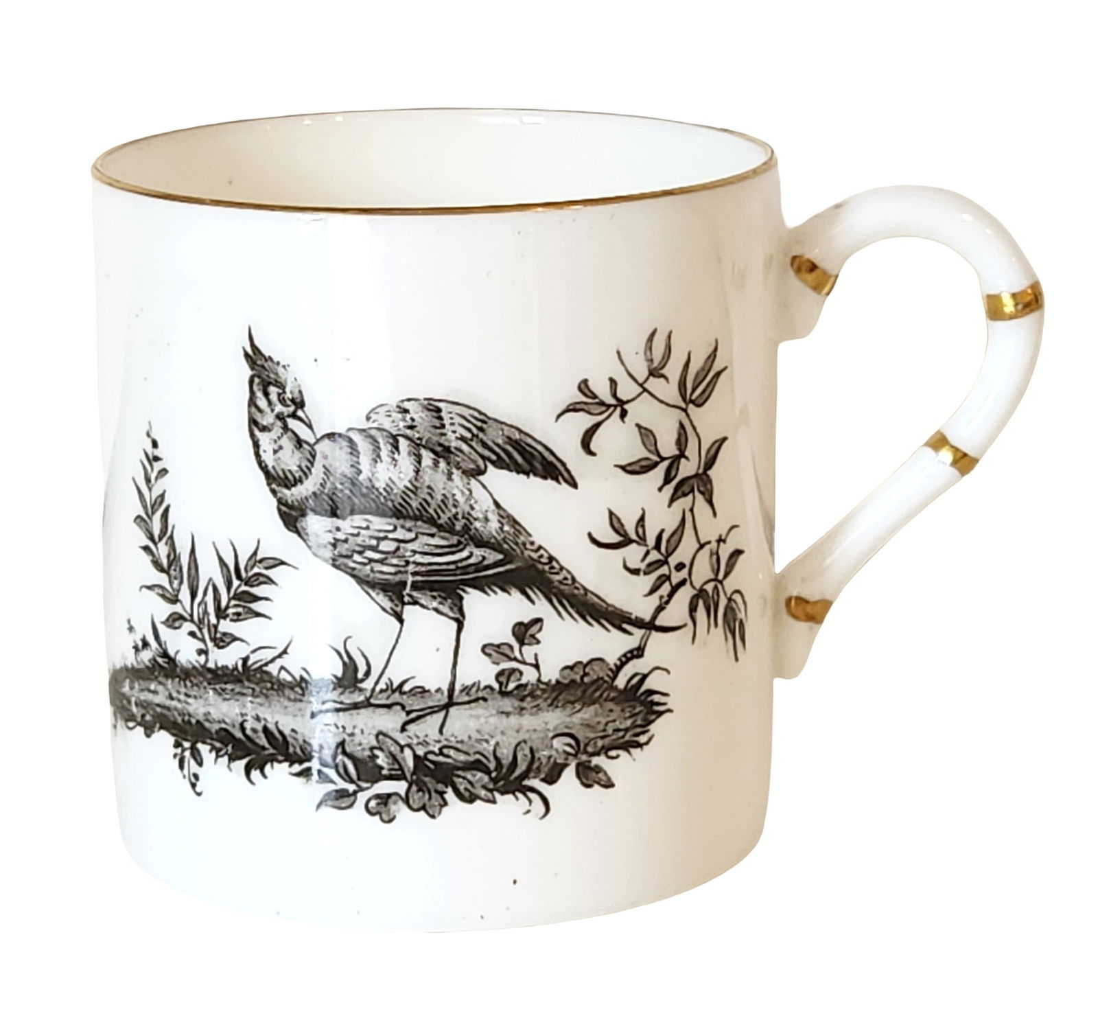 Porcelain Mug with Bird Decoration and Gilt Accents: Decorative white porcelain mug featuring finely detailed black transferware-style bird illustrations set in a natural landscape motif. The cylindrical body is accented with a gilt rim and a distinctiv