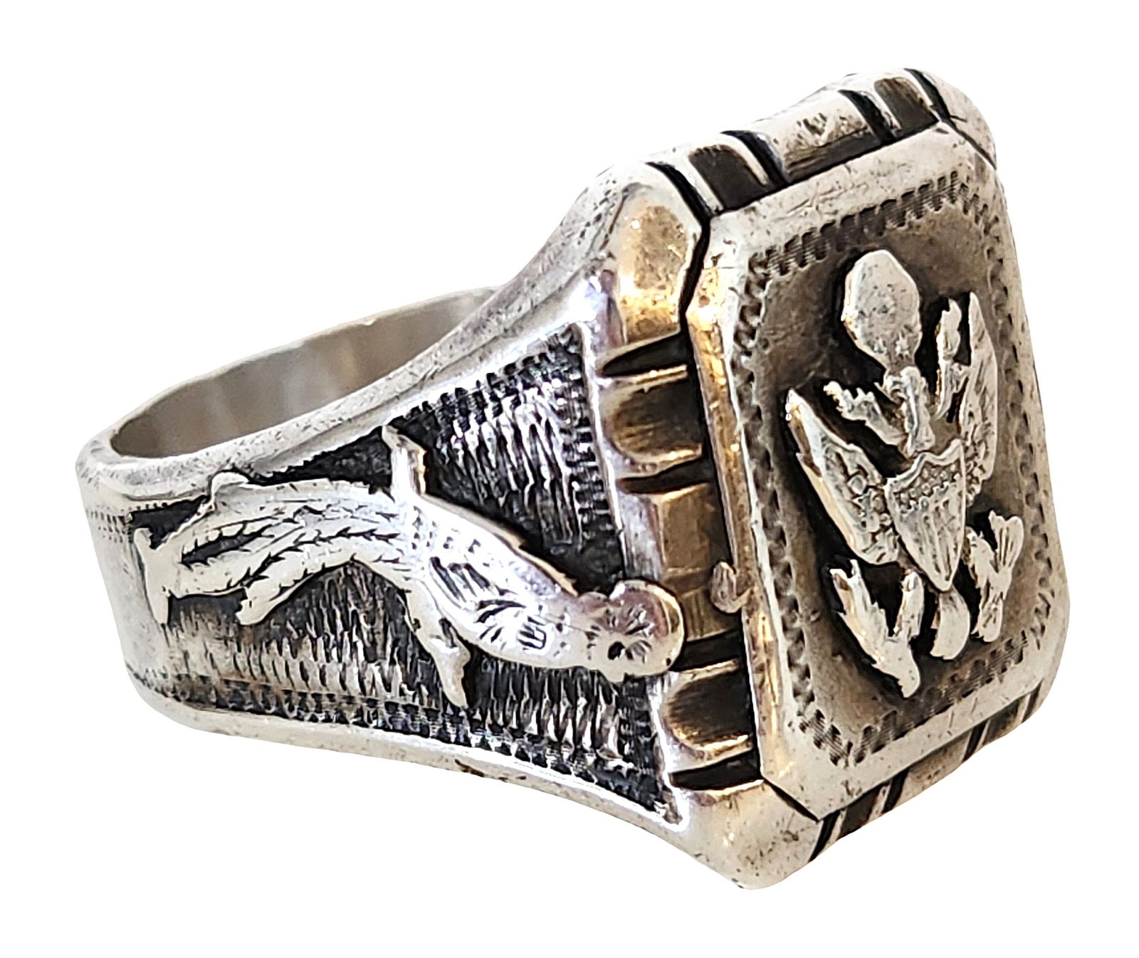 Vintage Sterling Silver U.S. Military Eagle Ring: A vintage sterling silver ring featuring a bold U.S. eagle emblem on the face. The square bezel displays a raised eagle with shield, clutching arrows and olive branches, symbolizing strength and natio