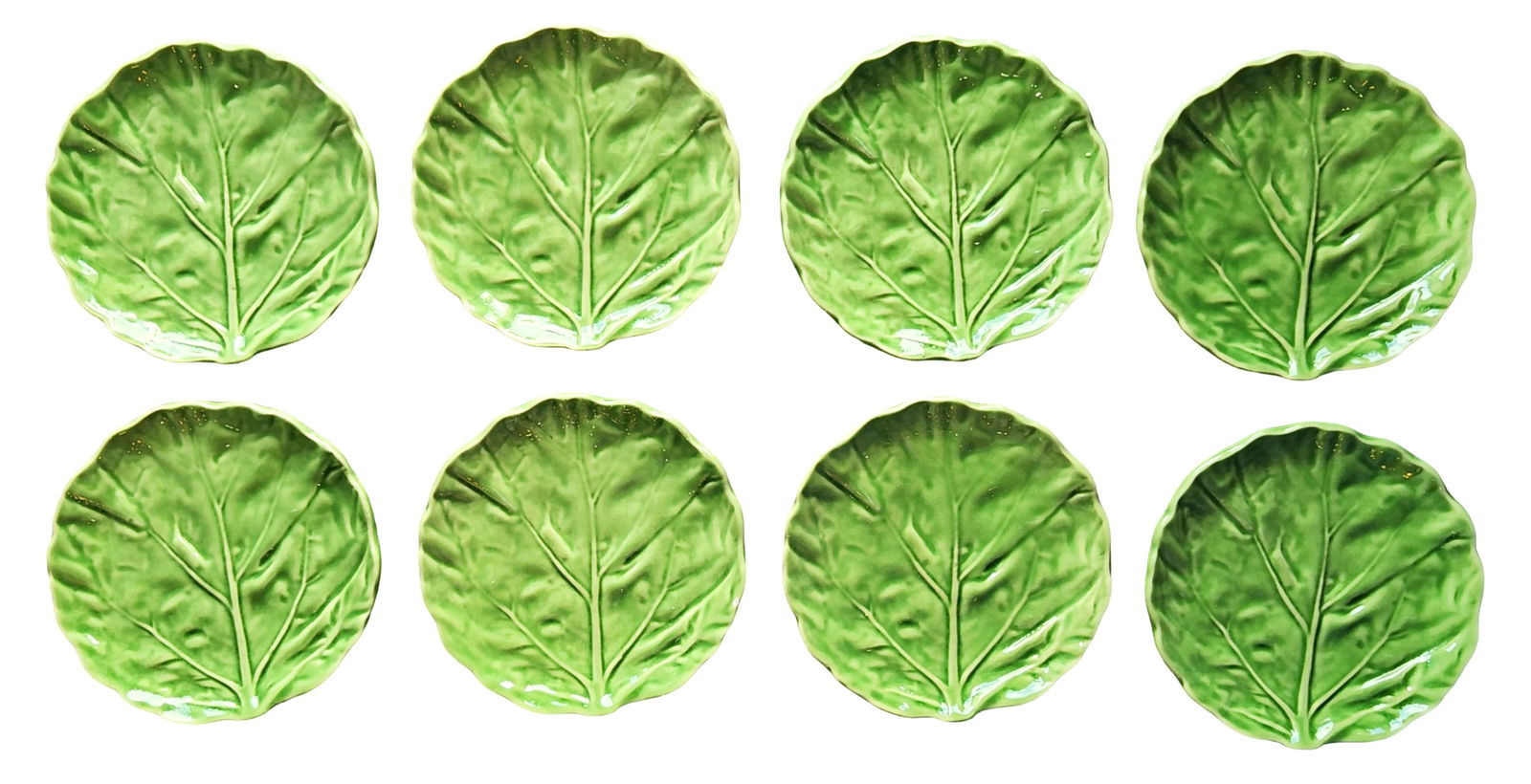 Set of Eight Italian Majolica Cabbage Leaf Plates: A set of eight Italian majolica pottery plates modeled in the form of cabbage leaves. Each plate is naturalistically molded with pronounced leaf veins and softly scalloped edges, finished in vibrant v
