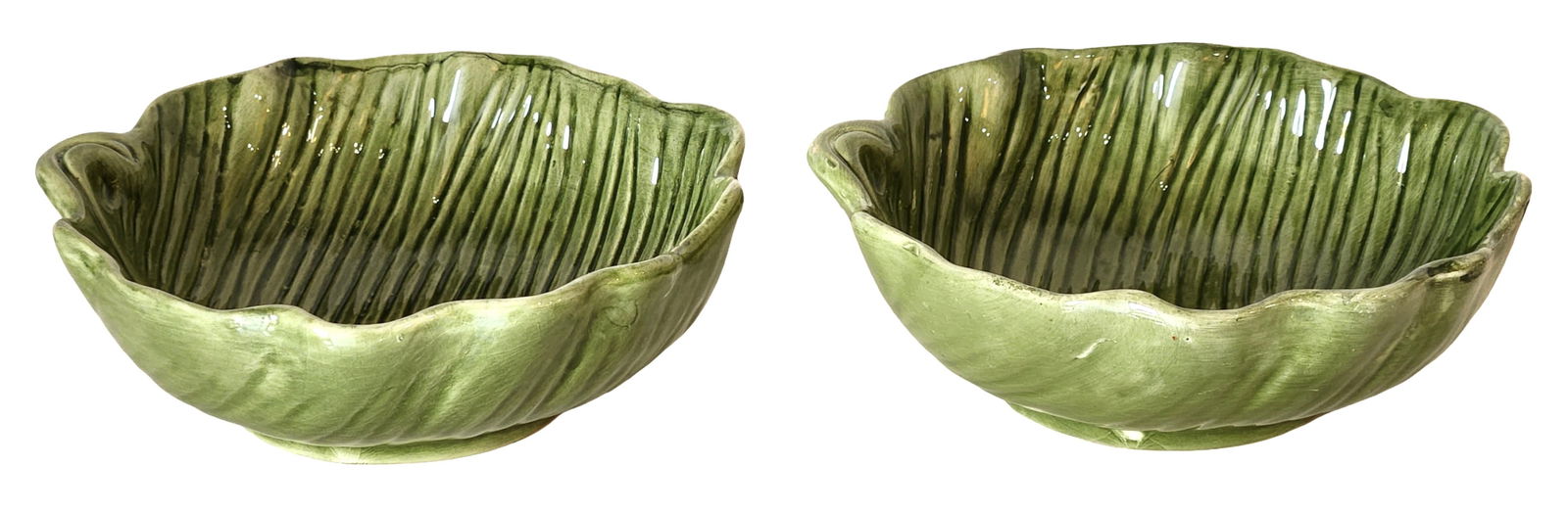 Pair of Hand-Painted Banana Leaf Form Ceramic Serving Bowls, Cardinal Inc.: A decorative pair of ceramic serving bowls modeled in the form of stylized banana leaves, featuring molded veining and a hand-painted green glaze that highlights the naturalistic texture of the leaf d