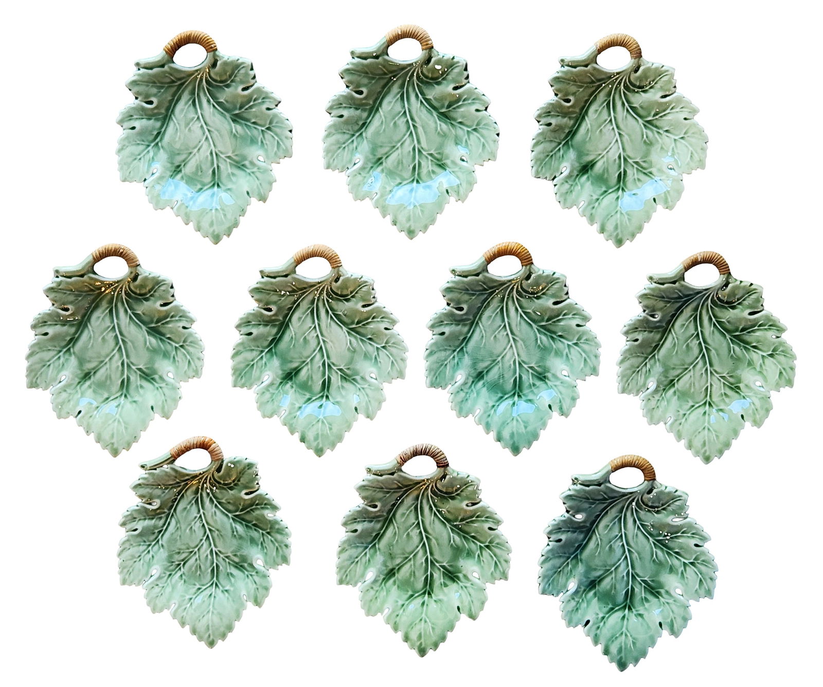 Set of Ten Leaf Form Ceramic Wall Pockets / Hanging Vases: A decorative set of ten ceramic wall pockets designed in the form of naturalistic leaves. Each piece features molded veining, softly scalloped edges, and a glossy green glaze with shaded detailing tha