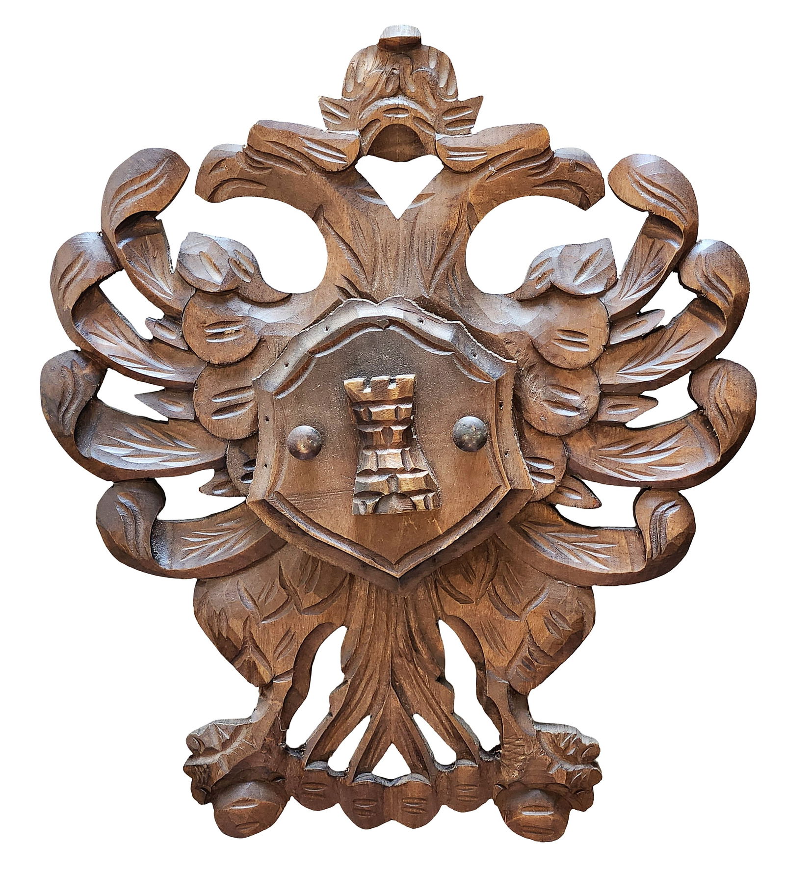 Carved Wooden Heraldic Wall Plaque with Shield Motif: Decorative carved wooden wall plaque featuring an ornate heraldic design. The plaque is carved in relief with scrolling foliage, stylized leaves, and symmetrical ornament surrounding a central shield.