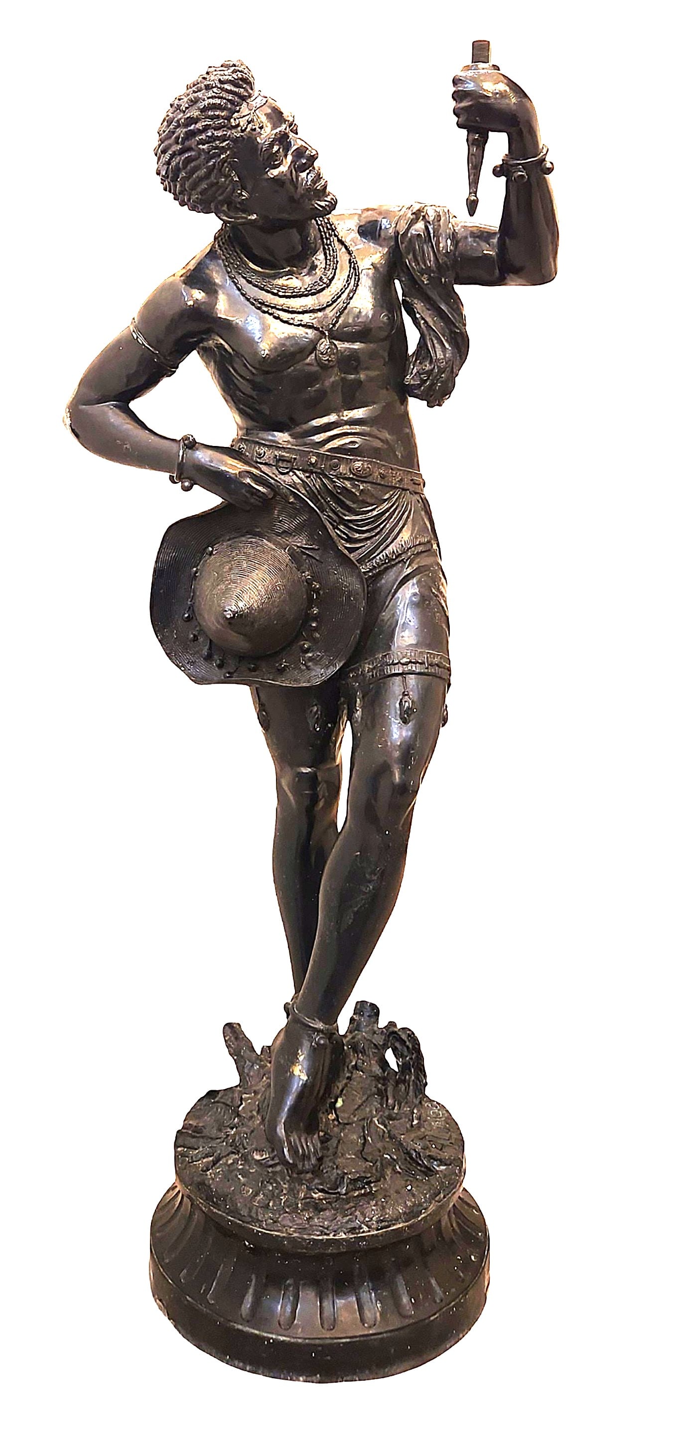Bronze Figure of an African Warrior, Signed A. Luciga: A striking bronze figure depicting an African warrior, shown in a dynamic contrapposto pose and holding a dagger aloft. The figure is finely modelled with strong anatomical detail, textured hair, and