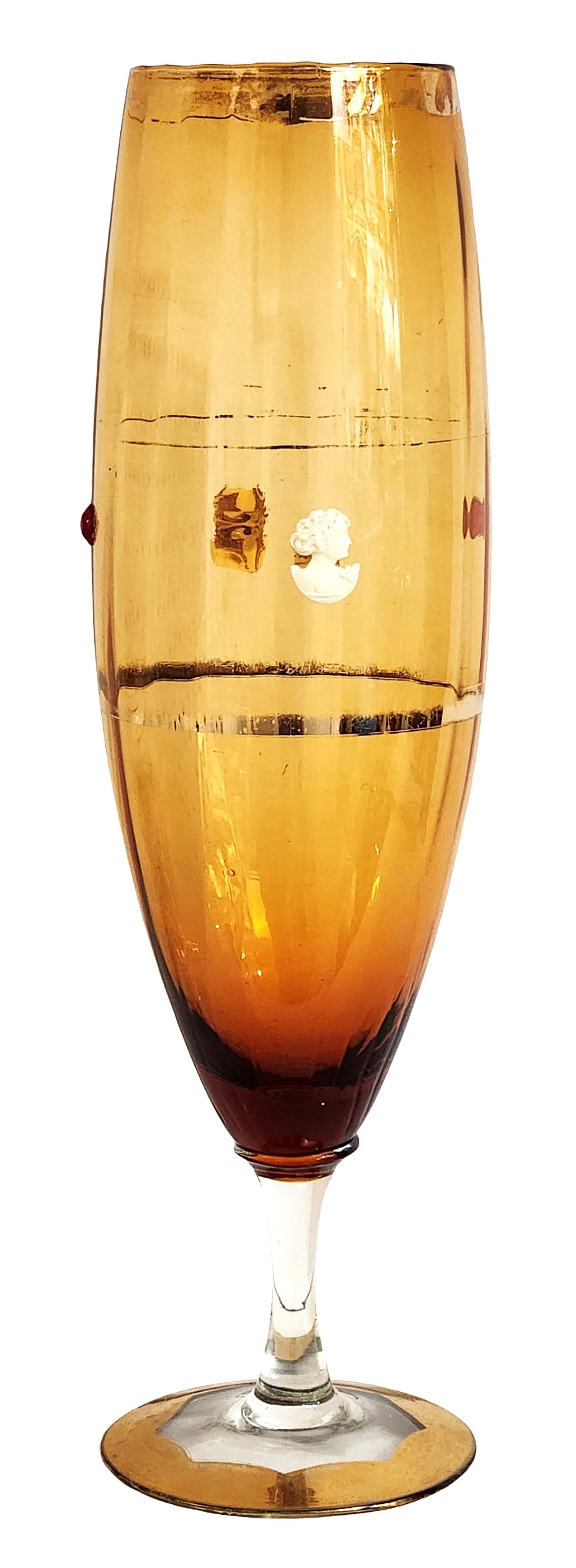 Amber Art Glass Champagne Flute with Cameo and Gold Rim: Elegant amber-colored art glass champagne flute featuring a warm gradient tone that deepens toward the base. The bowl is decorated with small applied decorative elements, including a classical white c