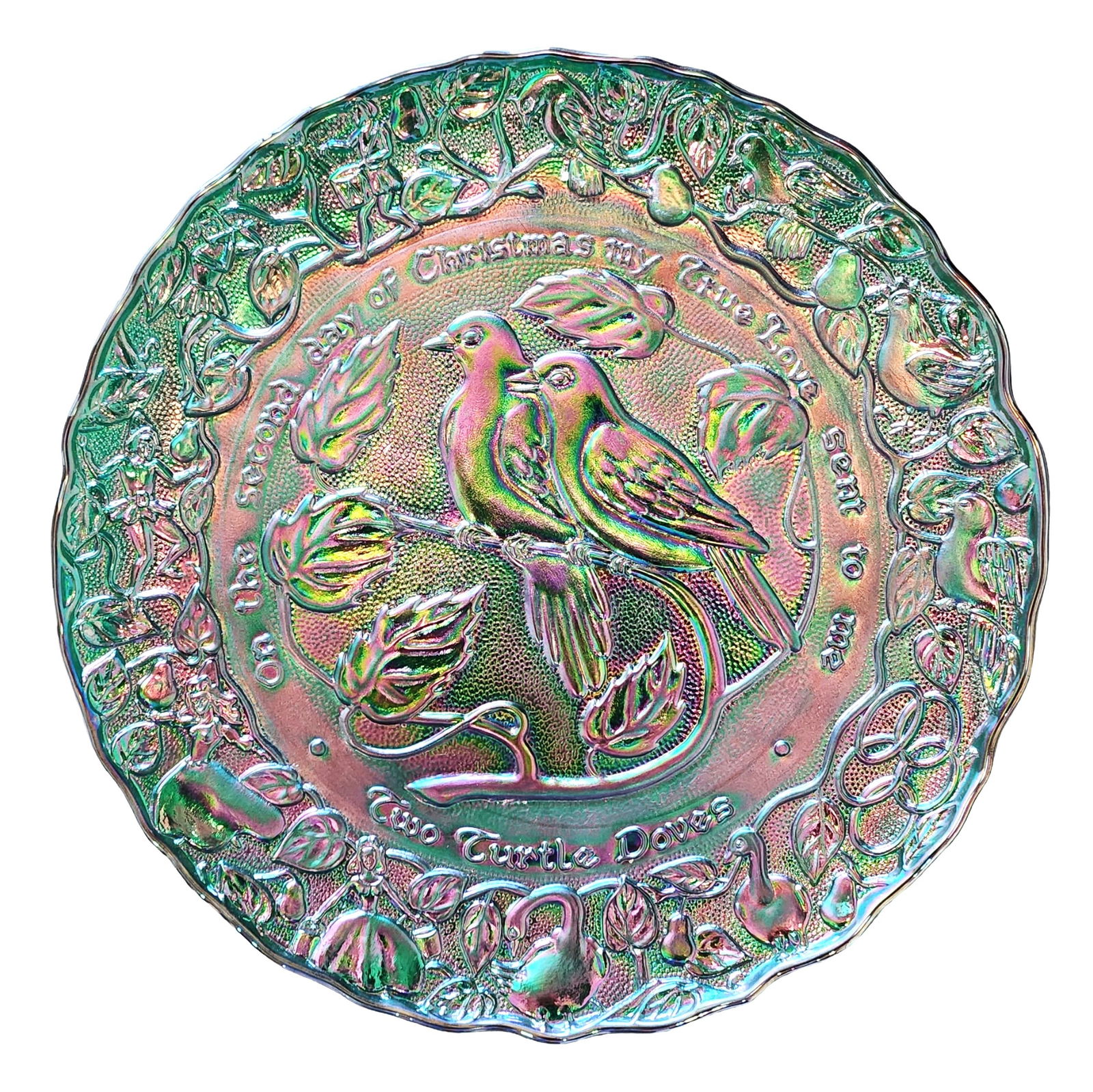 Fenton Carnival Glass “Two Turtle Doves?? Collector Plate – Green Iridescent: Decorative carnival glass collector plate in an iridescent green finish featuring the “Two Turtle Doves” design from The Twelve Days of Christmas series. The center depicts two turtle doves pe