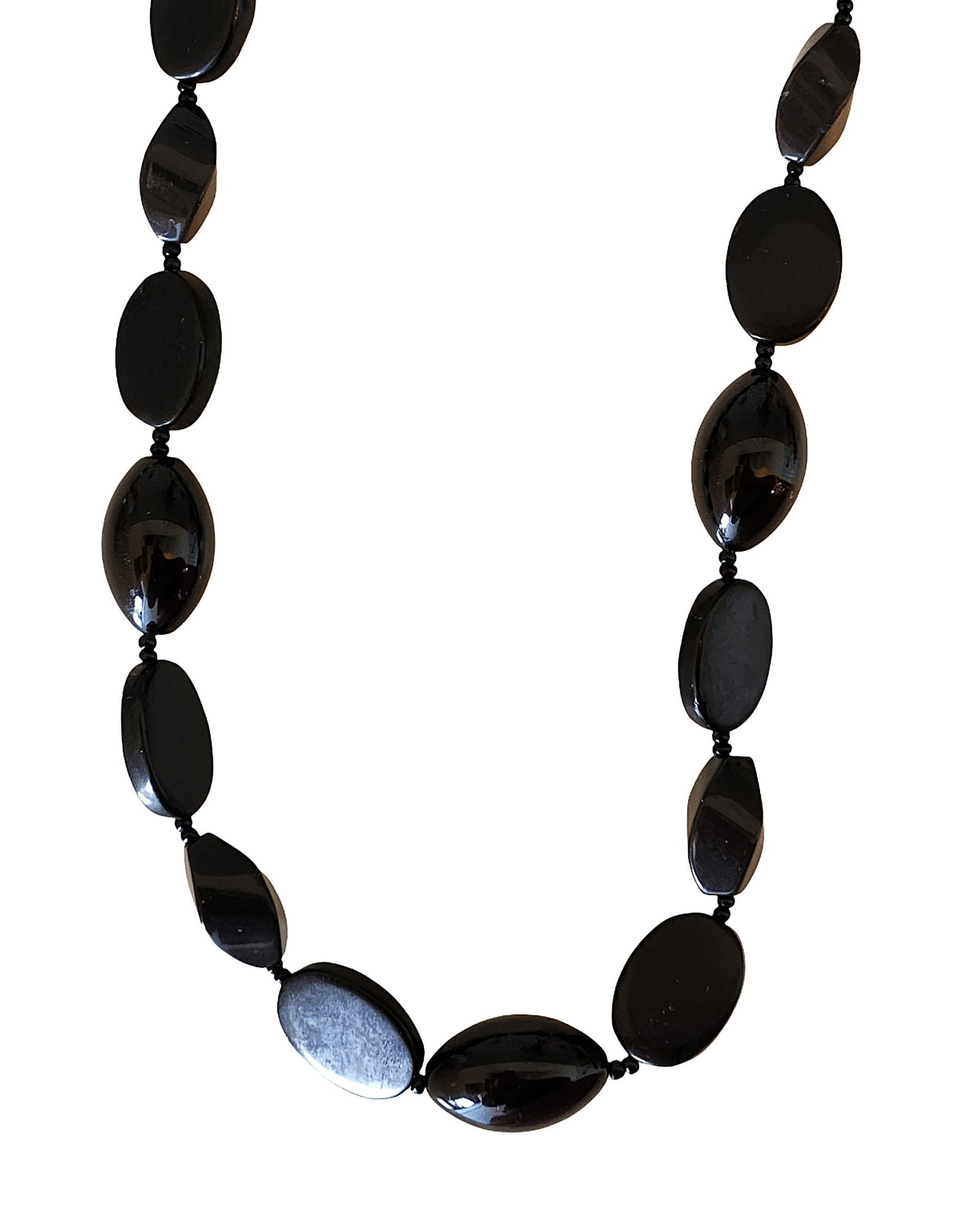 Polished Black Onyx Bead Necklace with Ring Clasp: Elegant necklace composed of polished black onyx beads in alternating oval and elongated shapes. The stones display a deep glossy black finish, creating a sleek and classic monochrome look The beads a