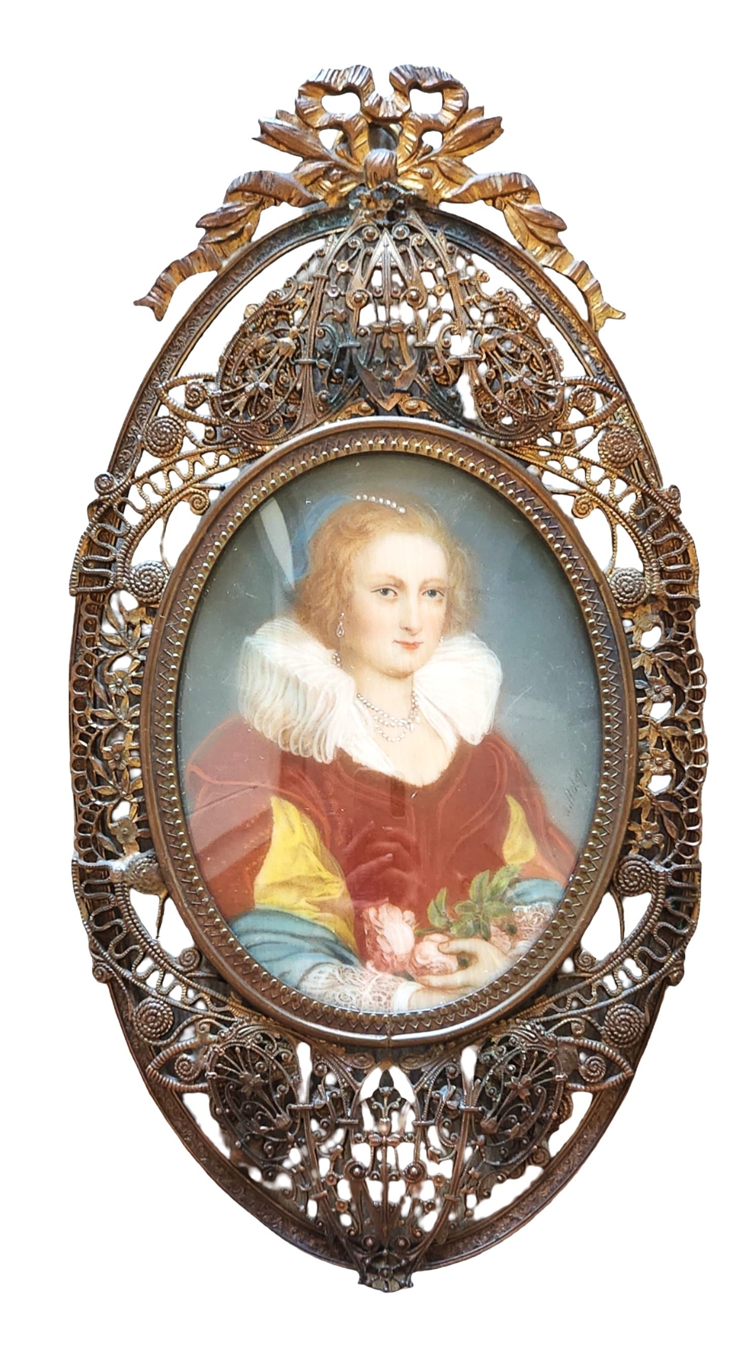 Continental Portrait Miniature of a Lady in Elaborate Gilt Filigree Frame: Continental hand-painted portrait miniature depicting a young woman in late 16th– or early 17th-century style dress, shown wearing a ruffled white collar, pearl jewelry, and richly colored garments.