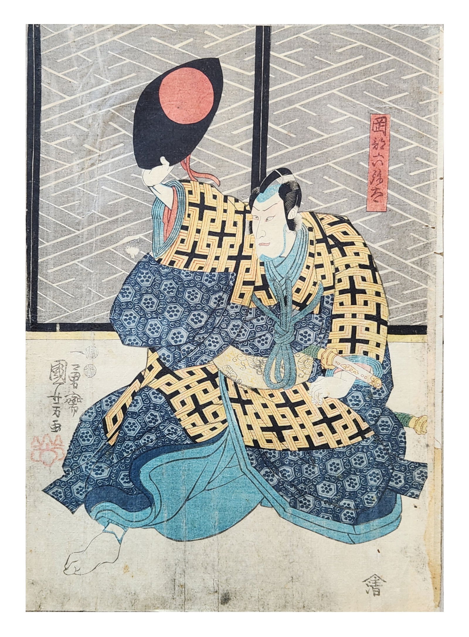 Japanese Ukiyo-e Woodblock Print of Kabuki Actor, Utagawa Kunisada (Toyokuni III), Edo Period: Japanese ukiyo-e woodblock print depicting a kabuki actor in dramatic pose, seated and raising a large black eboshi-style hat with a red roundel. The figure wears layered robes with bold geometric pat