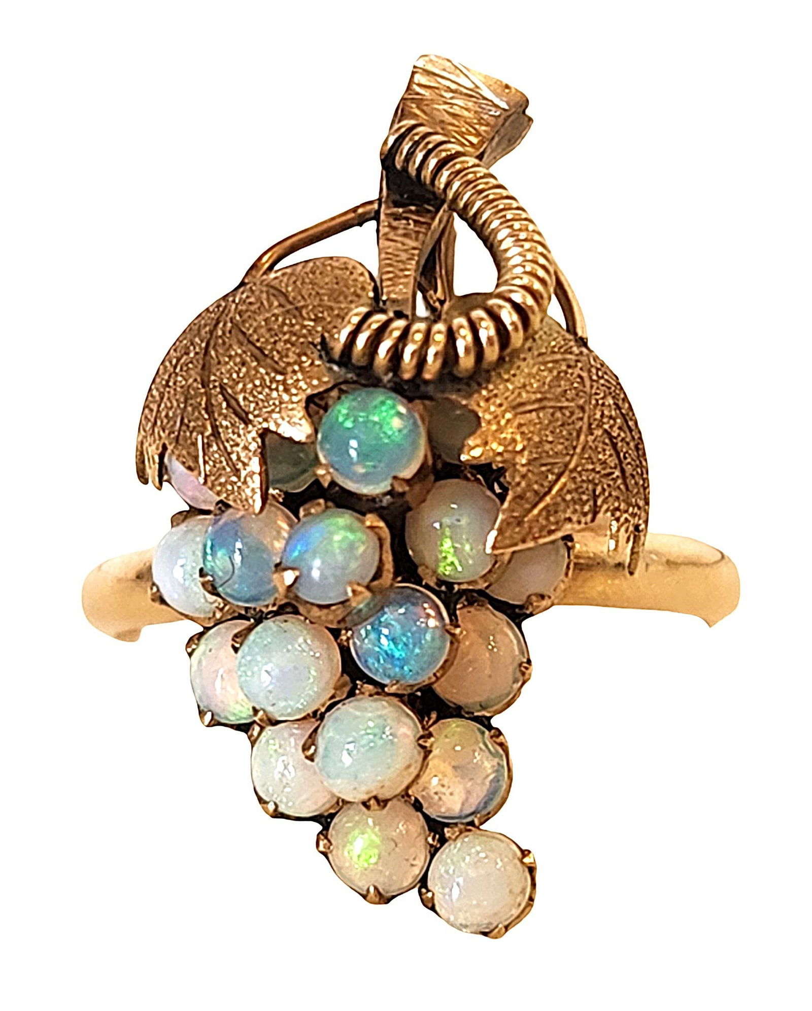 Antique 10K Yellow Gold Opal Grape Cluster Ring: Antique 10K yellow gold opal ring designed in the form of a grape cluster beneath a pair of detailed leaves and curling vine motif. The ring is set with numerous small round cabochon opals arranged to